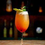 glass-orange-cocktail-garnished-with-mint-green-apple-slices-1536x1920