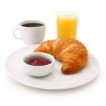 Continental Breakfast: croissant, jam, coffee and orange juice isolated on white (excluding the shadow)
